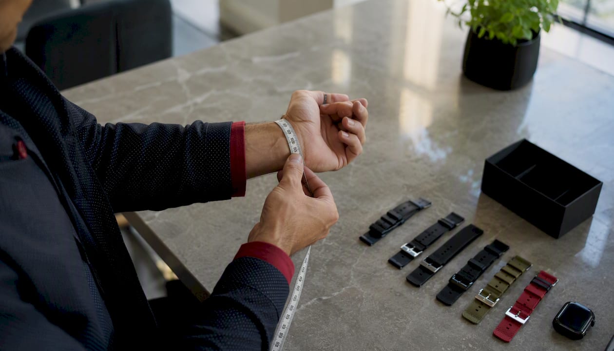Hands measuring wrist and watch lug width